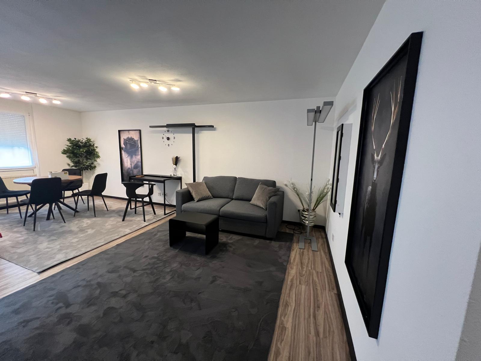 Living area with sofa, desk and dining table